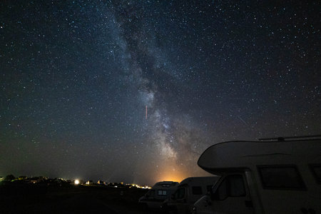 Night sky milky way core over overnight parked vans.の写真素材