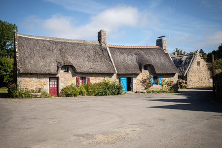 Traditional thatched roof cottage house in the charming Village of Kercarnic, Brittany (Bretagne), France.の写真素材