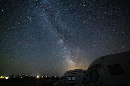 Night sky milky way core over overnight parked vans.の写真素材