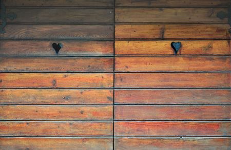 Detail of a wooden door with heart decorationsの写真素材