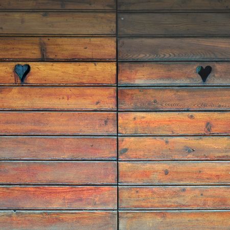 Detail of a wooden door with heart decorationsの写真素材