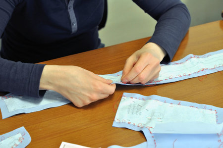 A sewing professional tailor at work making cloth