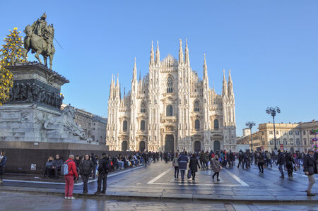 Tourists in Piazza Duomo in front of the Duomo di Milano gothic cathedral church Milan Italyのeditorial素材