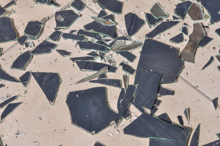 Broken mirror glass shards spread on the floorの写真素材