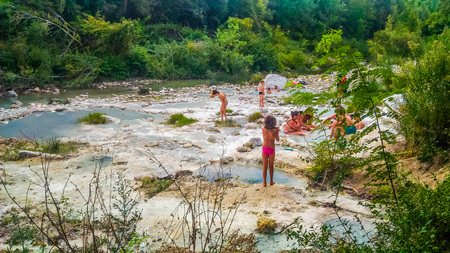 PETRIOLO, ITALY - CIRCA AUGUST 2016: High_dynamic_range (HDR) Tourists at public spa bathsのeditorial素材