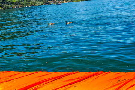 LAKE ISEO, ITALY - CIRCA JUNE 2016: High_dynamic_range (HDR) The Floating Piers site specific artwork by Christo and Jeanne Claudeの写真素材