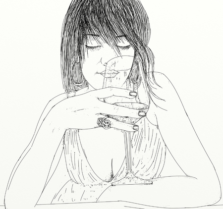 woman with glass sniffing wine with wind in her hair.の写真素材