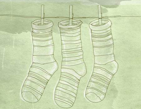 three striped socks spread with clothespins