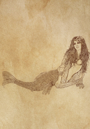 Long-haired mermaid leaning to her side and facing the viewerの写真素材