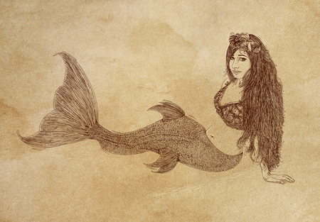 Long-haired mermaid leaning to her side and facing the viewerの写真素材