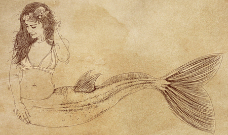 Long-haired mermaid leaning to her side and facing the viewerの写真素材