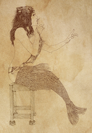 Long-haired mermaid leaning to her side and facing the viewerの写真素材