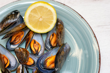 plate of steamed mussels with half a lemon