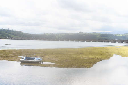 Old boat on a river, a foggy day in Cantabria, Spain.の写真素材