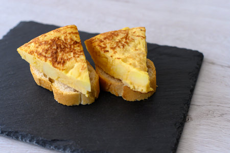 Two skewers of Spanish potato omelette. Typical food of the Spanish Mediterranean diet