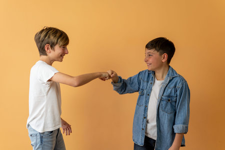 Two children greet each other by bumping fistsの写真素材