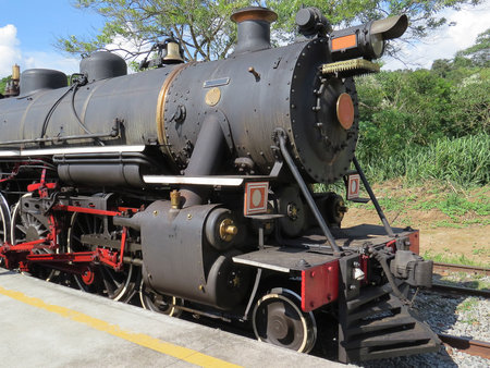Steam locomotive, stop at small railway station, on sunny day