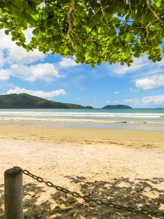 Landscape of deserted beach with island in the background, in summer day.の写真素材