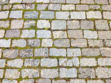 Top view of old street floor of granite stones horizontally.