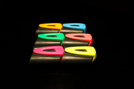 Multicolor  marker pen caps stack isolated on black close-up