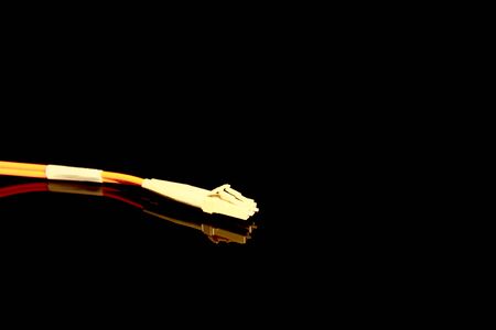 Twin optical fiber connectors  isolated on black with reflectionsの写真素材