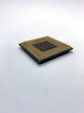 Single microprocessor with pins up close-up view isolated on white