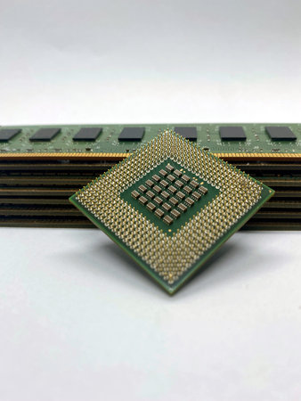 Microprocessor CPU on a stack of RAM memory chips close-up isolated on white background