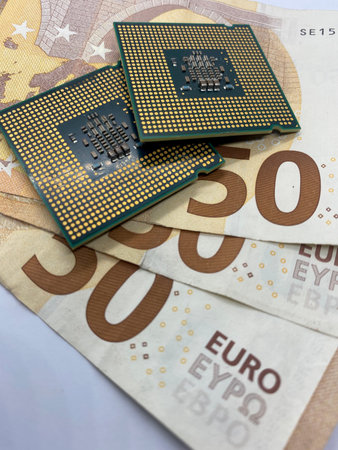 Close-up of microprocessors CPU on EURO banknotes with selective focus on foreground