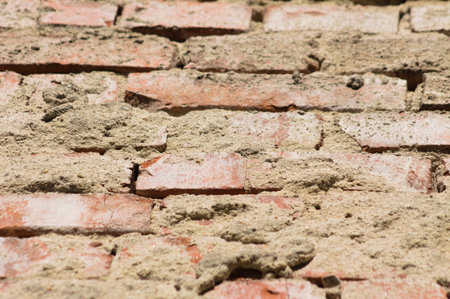 Close-up of old brick wall with selective focus on foregroundの写真素材