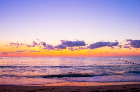 Beautiful cloudscape over the sea, colorful sea beach sunriseの写真素材