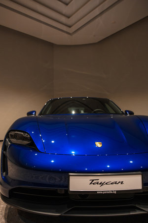 Circa 2023 - Sofia, Bulgaria: A blue shiny new Porsche Tacan car on display on a conference room.のeditorial素材