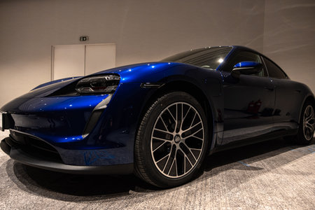 Circa 2023 - Sofia, Bulgaria: A blue shiny new Porsche Tacan car on display on a conference room.のeditorial素材