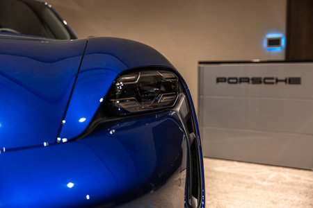 Circa 2023 - Sofia, Bulgaria: A blue shiny new Porsche Tacan car on display on a conference room.のeditorial素材