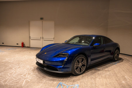 Circa 2023 - Sofia, Bulgaria: A blue shiny new Porsche Tacan car on display on a conference room.のeditorial素材
