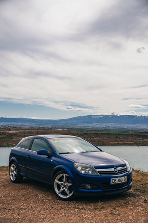 Sofia, Bulgaria - circa May 2022 - Blue Opel Astra in front of the former Kremikovtsi mine.のeditorial素材