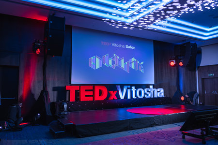 Circa 2023, Sofia, Bulgaria: The TEDxVitosha conference letters on the stage. Screen shows a video.のeditorial素材