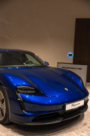 Circa 2023 - Sofia, Bulgaria: A blue shiny new Porsche Tacan car on display on a conference room.のeditorial素材