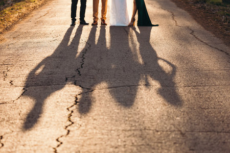 Shadow silhouette at sunset. Friends forever concept on a road. High quality photoの写真素材