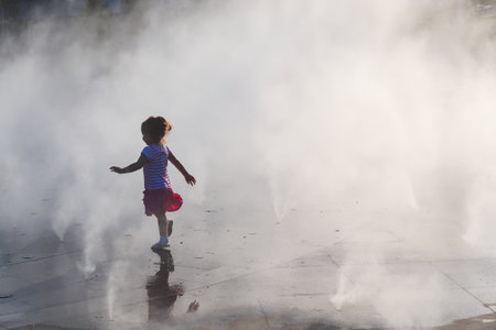 A child runs through steam attractionの写真素材