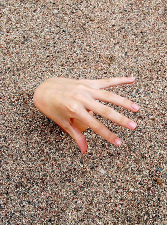 Hand over sand