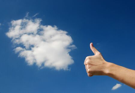 Hand over sky and cloudsの写真素材