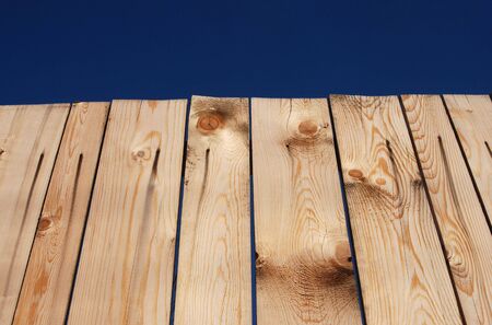 Wooden fence over blue skyの写真素材