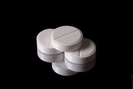 White pill in close up with reflex 