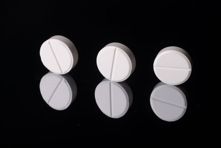 White pill in close up with reflex 