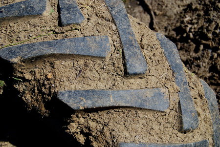 Muddy dirty tractor tire in close up