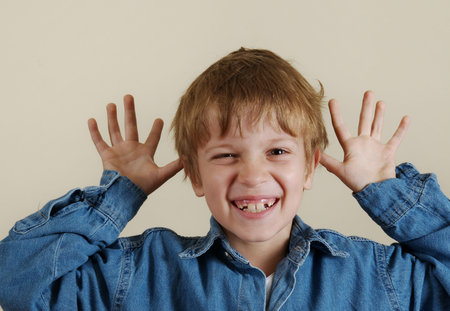 Young caucasian gesturing boy in blue shirt