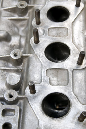 Part of car engine, holes for exhaust at head 