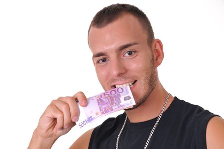 Young Caucasian man biting euro banknotes isolated on whiteの写真素材