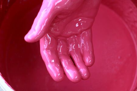 Painter checking paint with handの写真素材