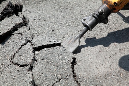 Close up of asphalt demolishing with pneumatic plugger hammerの写真素材